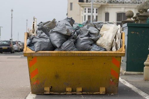Trucks loading items for disposal in Whitechapel