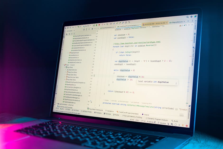 A close-up of a computer screen displaying lines of code with multicolored syntax highlighting, including keywords, variables, and functions, on a dark background. The screen is slightly tilted, with